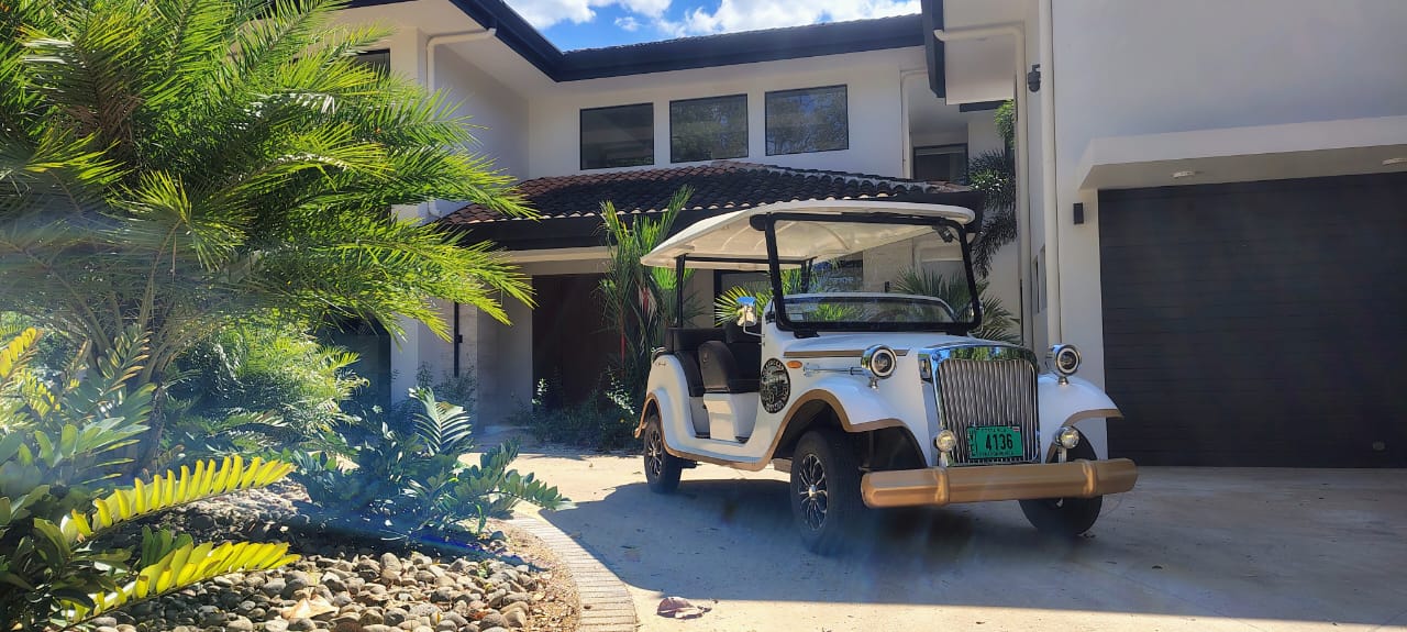 Classic vintage golf cart - side view at luxury villa